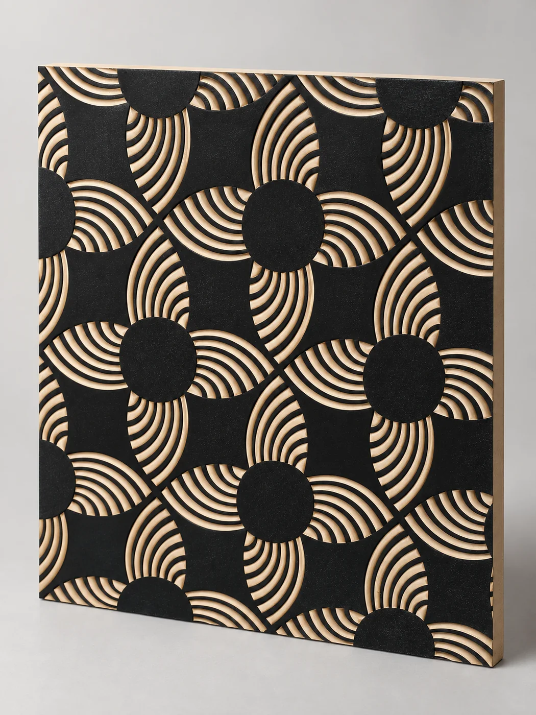 Black decorative panel with repeating concentric carved arcs