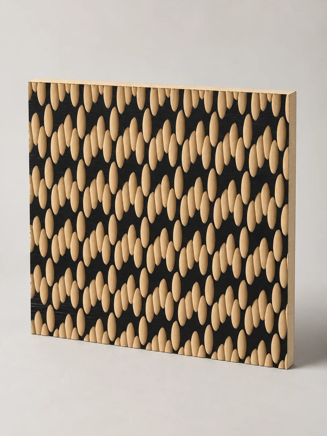 Black decorative panel with a repeating oval carved texture
