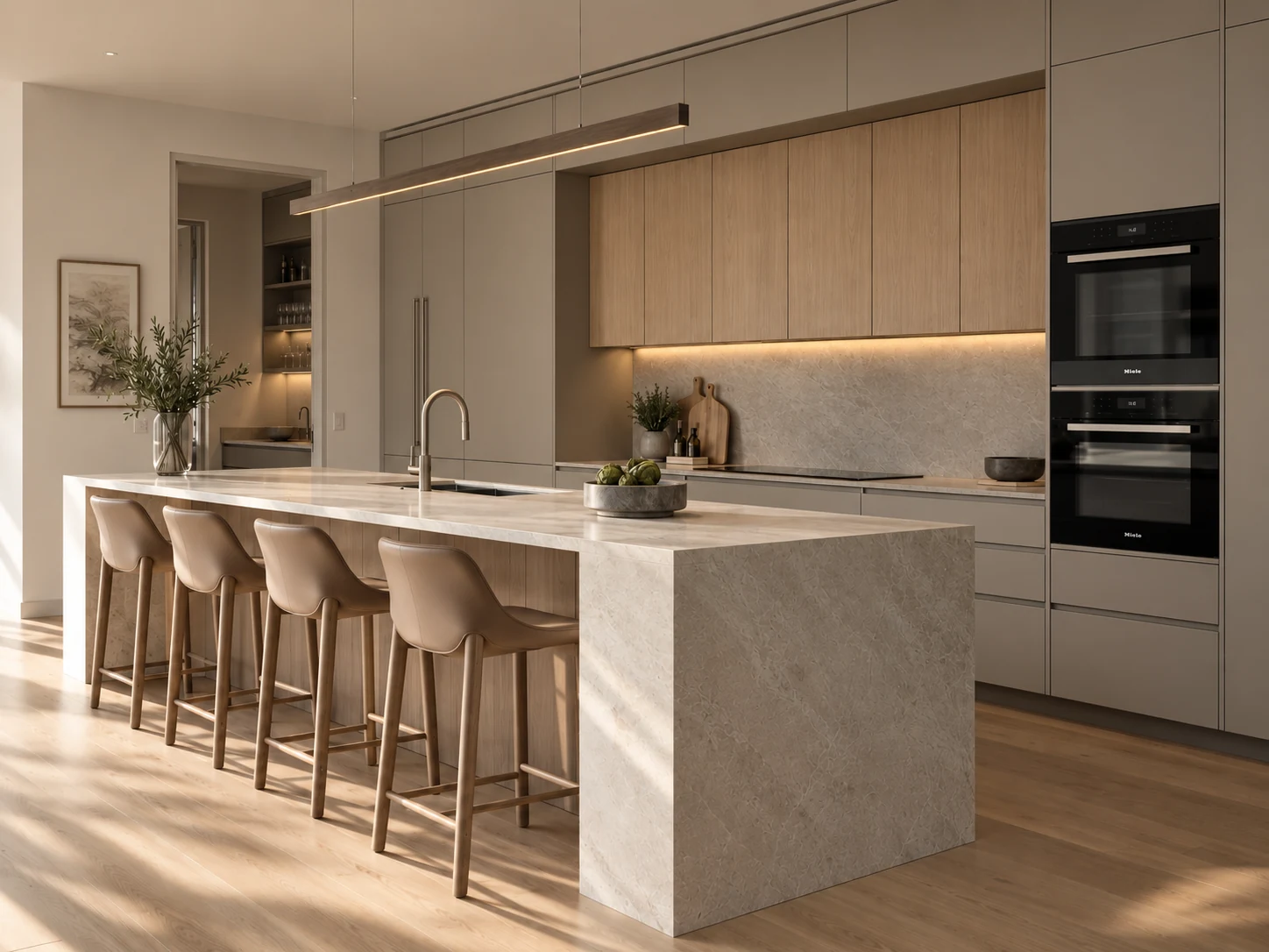 Warm taupe and oak kitchen with a pale veined stone waterfall island