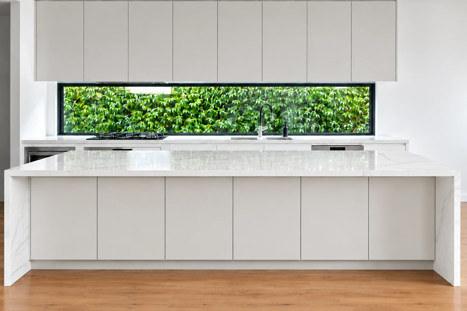 Minimal white kitchen with a stone island and a long garden window