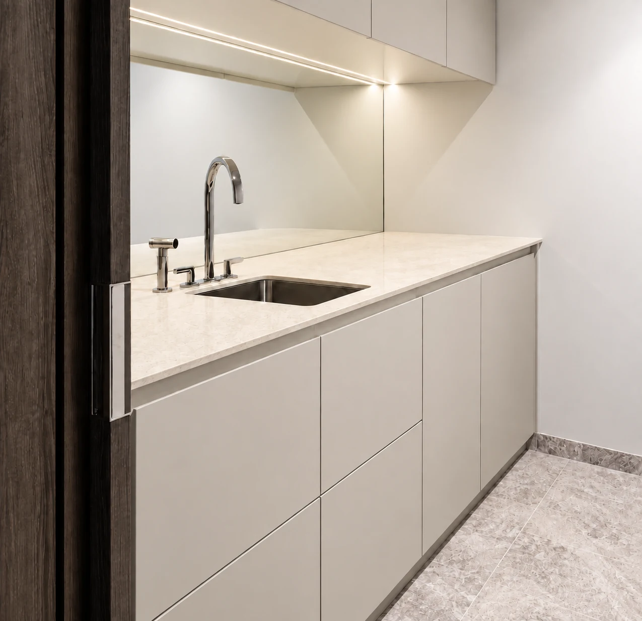 Soft greige utility cabinetry with an ivory worktop and stainless steel sink