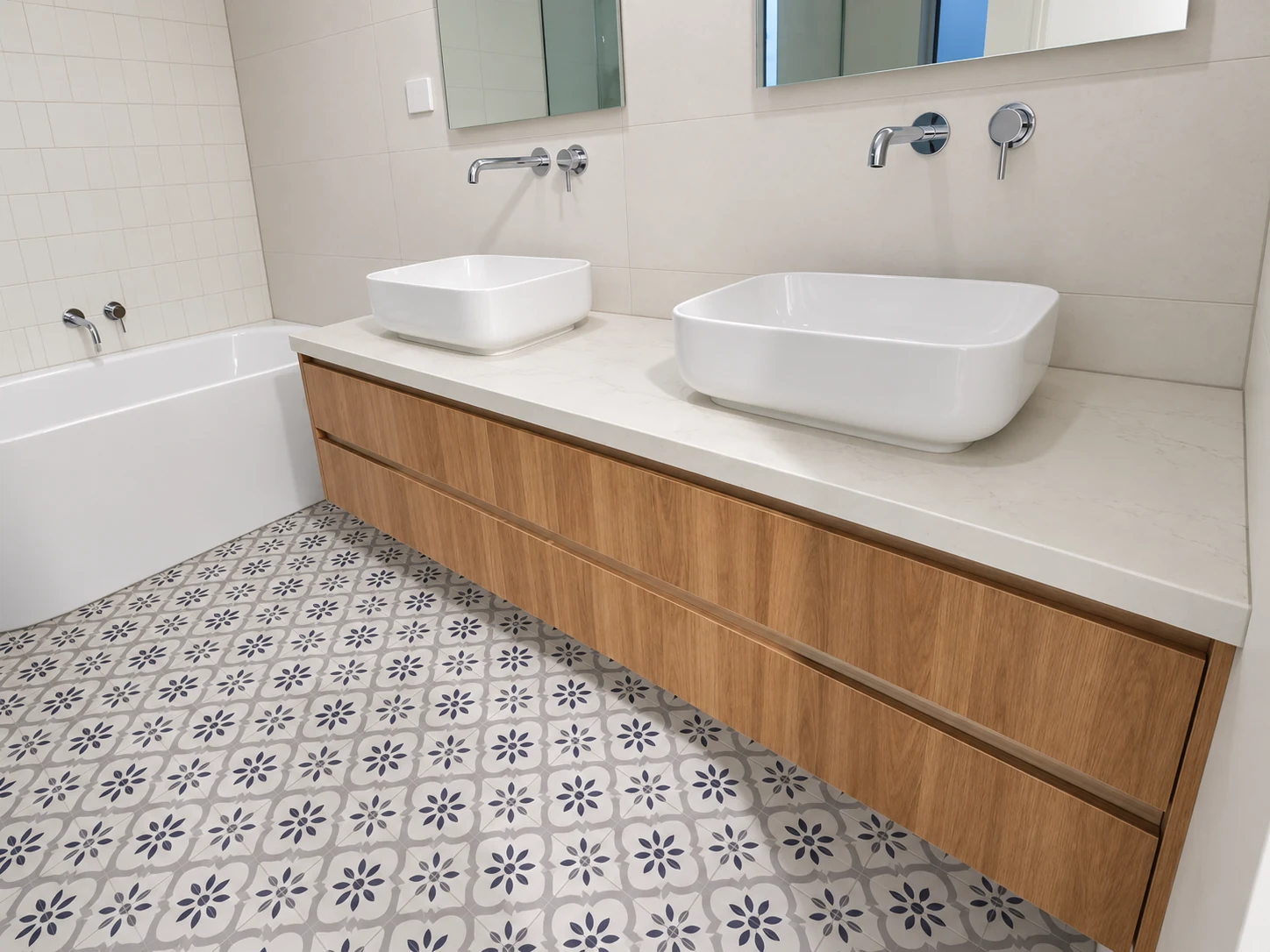 Timber double vanity with white vessel basins and patterned floor tiles